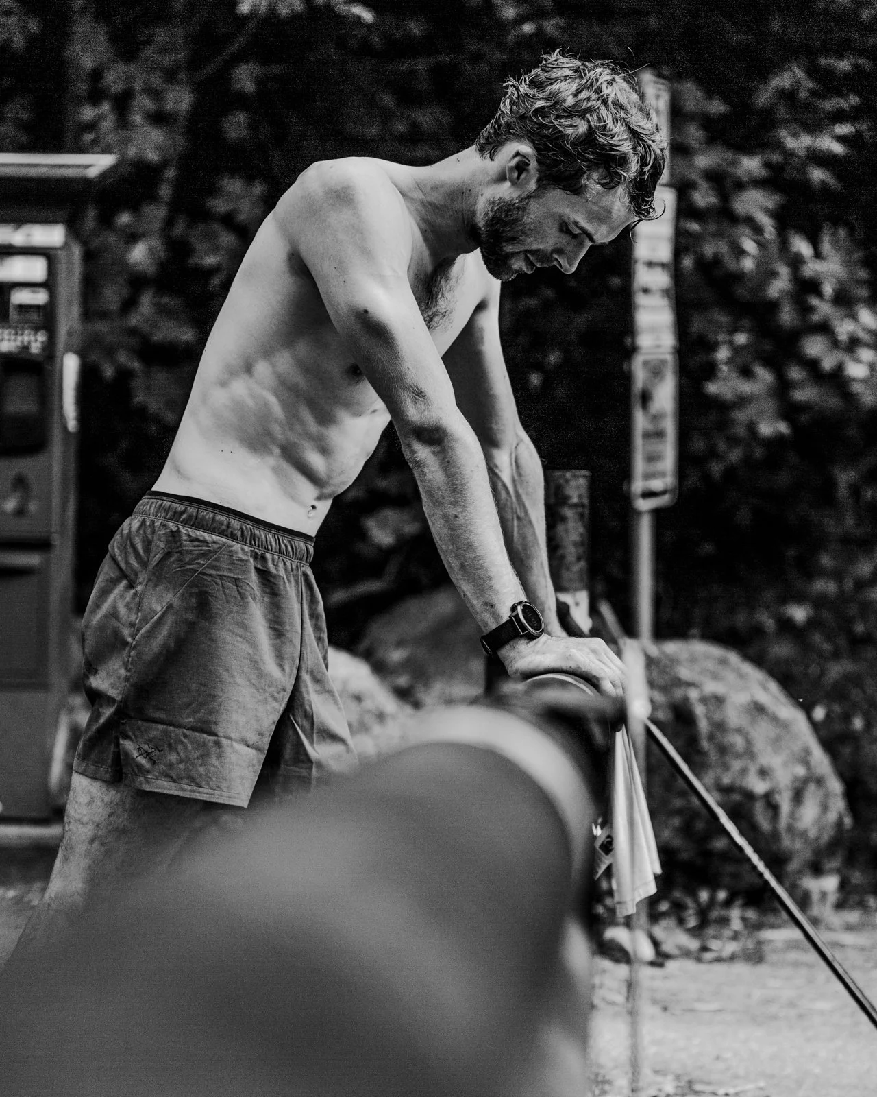 Climber belaying partner on outdoor rock face during academy event