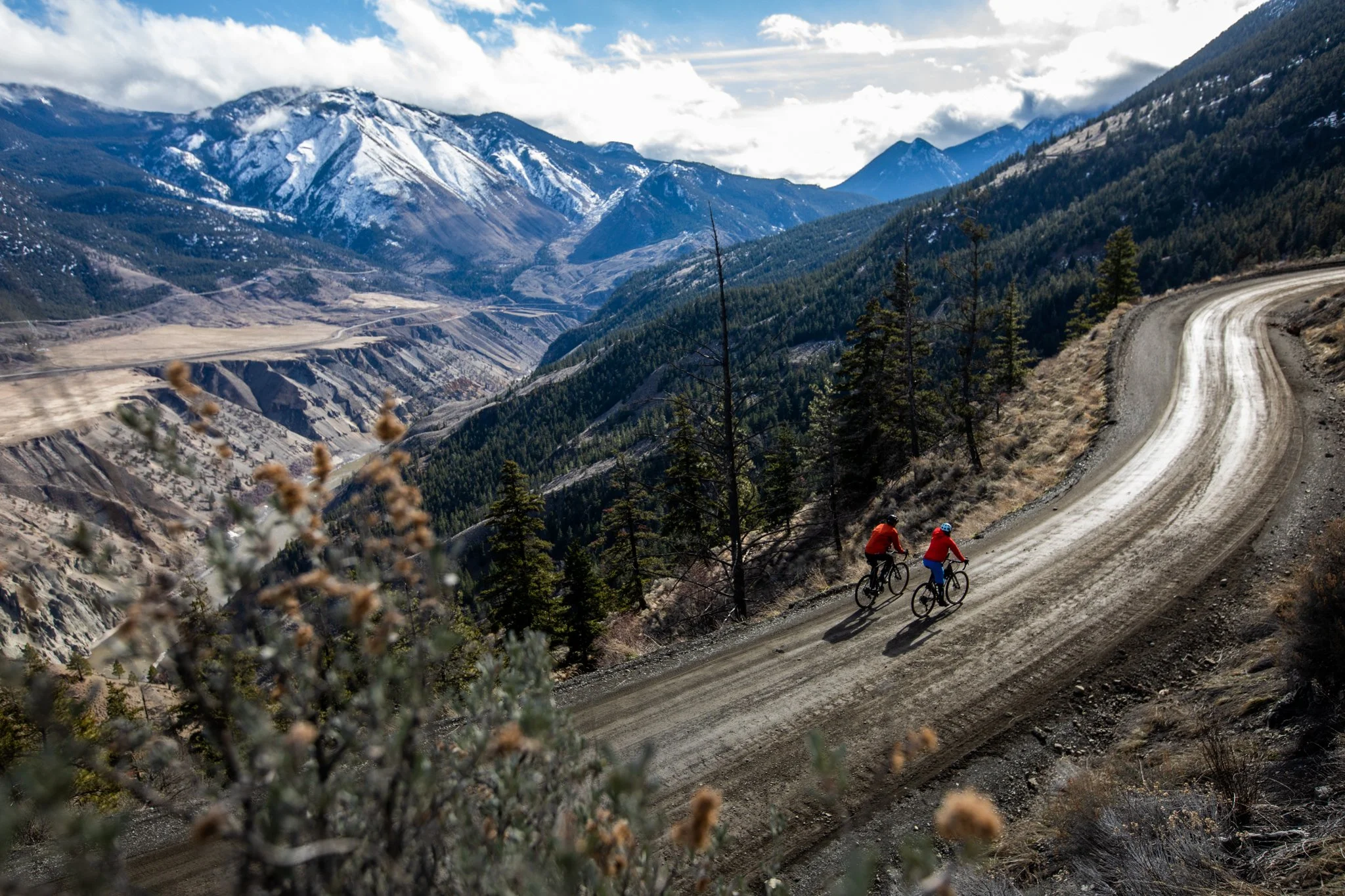 Editorial portrait of cyclist resting alongside mountain highway