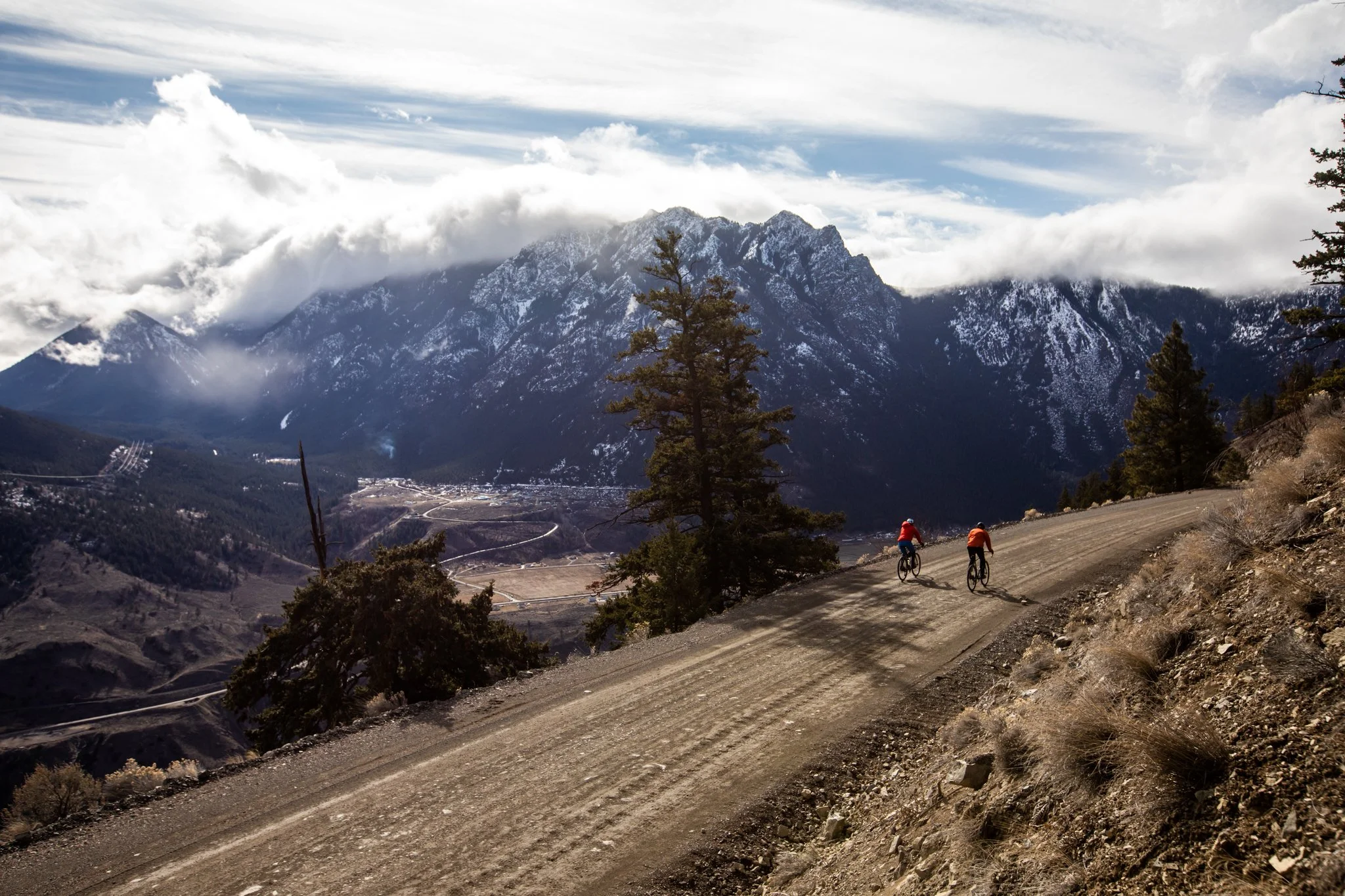 Aerial view of cyclist on winding coastal road in British Columbia