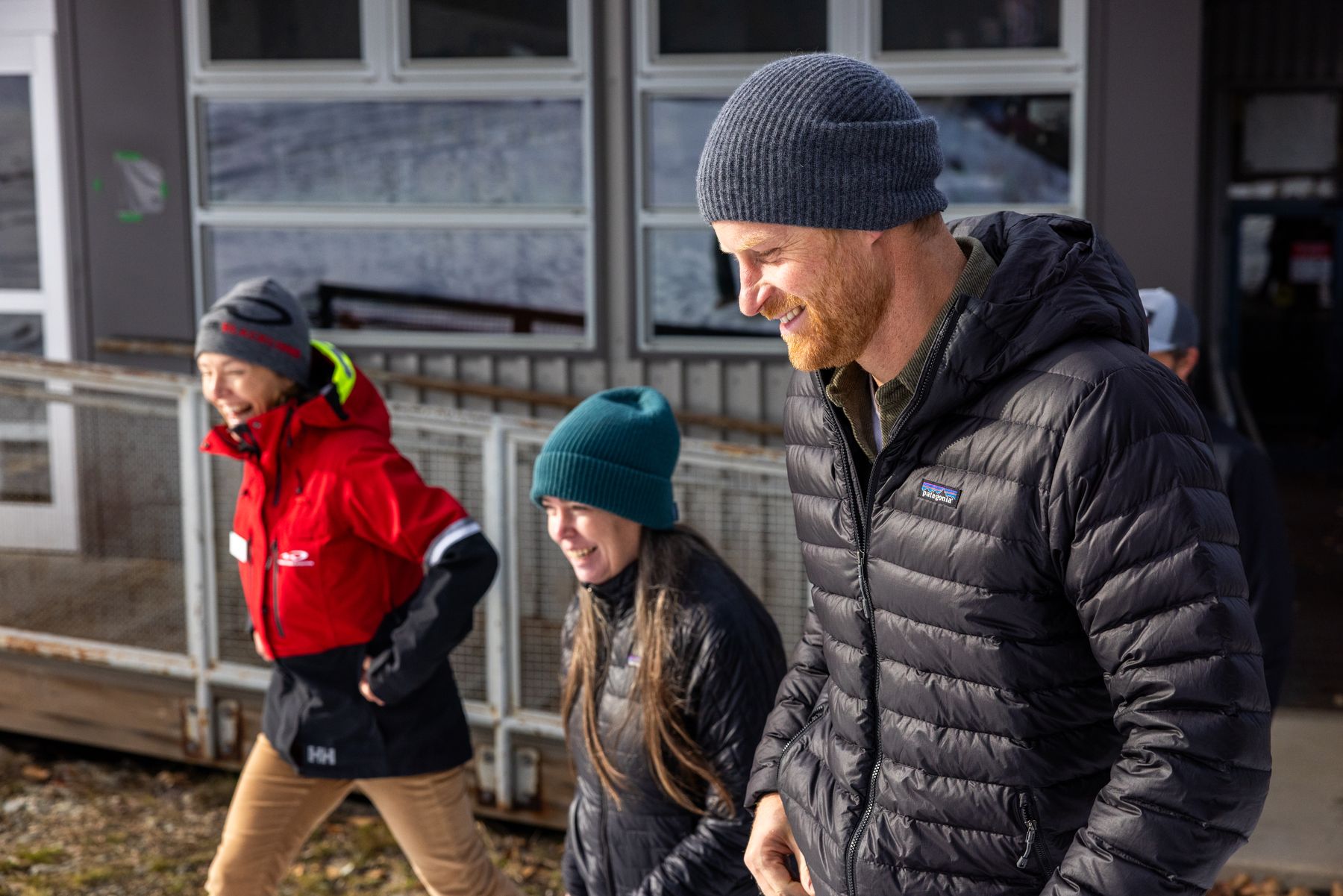 Prince Harry walking and laughing with Invictus Games team members at Whistler Blackcomb