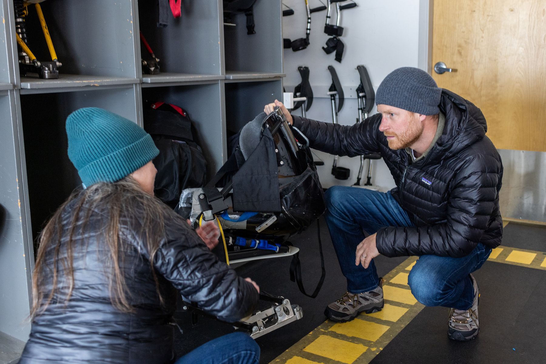 Prince Harry looking at adaptive ski equipment in a Whistler gear room
