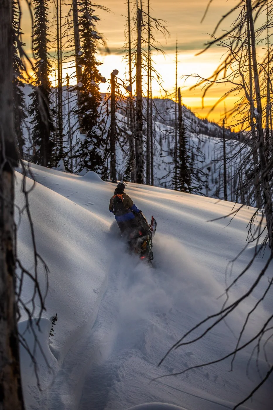 Backcountry skier descending steep alpine face during TGR filming