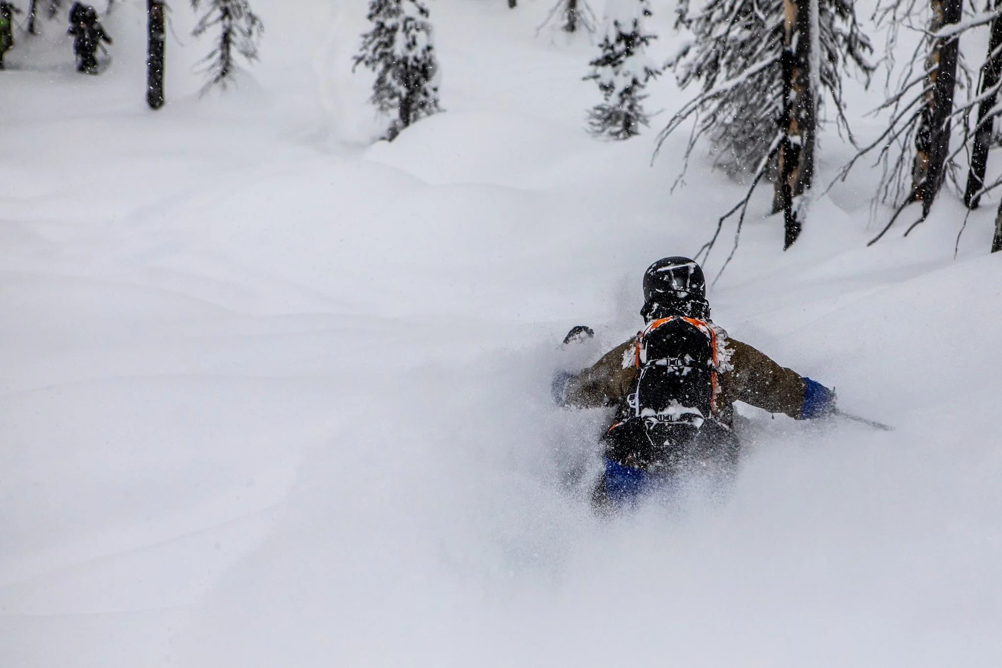 Wide angle shot of skier on remote alpine peak at golden hour