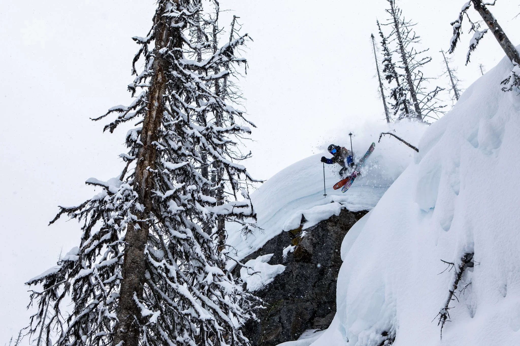 Athlete hiking ridge with skis for Teton Gravity Research shoot