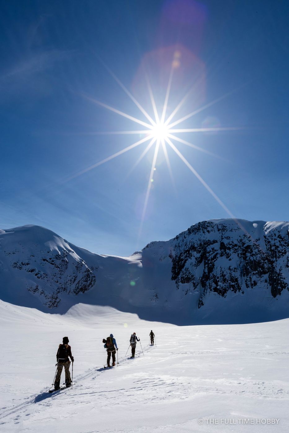 Ski Tourers Under a Sunstar, Alaska